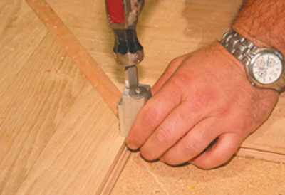 One swing of the hammer on the corner chisel punches a clean right angle.