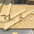 This custom-built jig, consisting of a plywood sled that glides across a saw table, is designed to cut all the pieces necessary for a French knot pattern.
