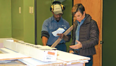 Smith explains job details to employee Alfonzo Elliott.