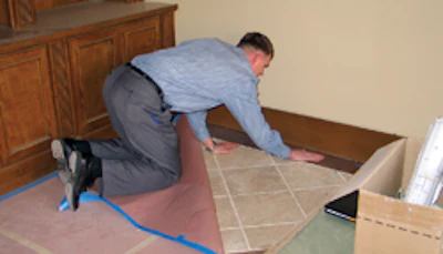 Van Blaricom inspects flooring in a multimillion dollar house in Olympia Hills.