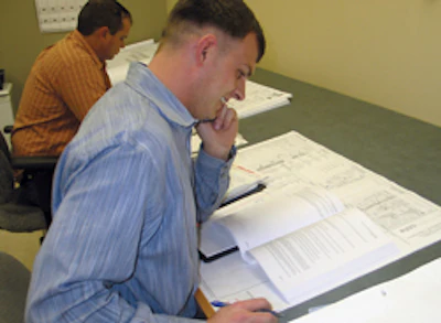 Van Blaricom inspects the plans for a job.