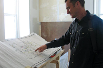 Downs takes a look at plans at the site office for an Upper East Side townhouse project.