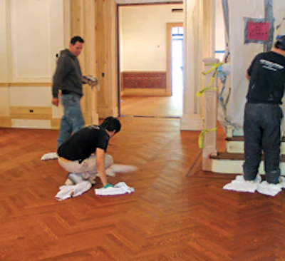 Downs' crew examines a stained floor for bleedback.