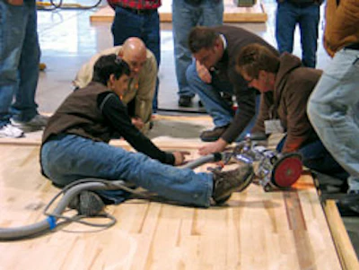 Photo of Steve Seabaugh discussing edging with Manny Navarro and classmates