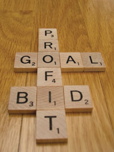 Photo of a scrabble board listing the words bid, goal and profit
