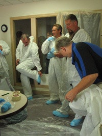 Contractors try on dust suits during a Lead Safe Renovator class in Madison, Wis.