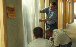 Contractors at a Lead Safe Renovator class in Madison, Wis., prepare a doorway for dust containment.