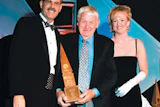 photo of Birger Juell collecting a Floor of the Year trophy