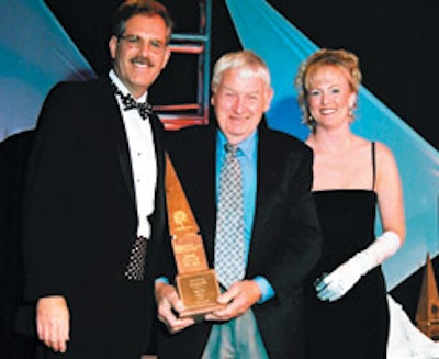 photo of Birger Juell collecting a Floor of the Year trophy