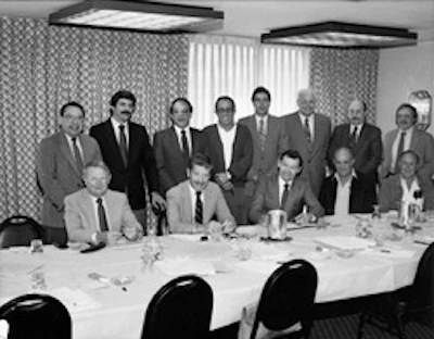 At this meeting in St. Louis in December 1985, the National Wood Flooring Association was officially created. Seen are (seated, left to right): Jack Wilcox, H.G. Roane Company; Ralph Singer, Diamond 'W' Supply; Lon Musolf, Lon Musolf Flooring; Roland Holder, Gentry & Holder Floors; Harold Reid, Trinity Floor Company; (standing, left to right): Gary Reynolds, Galleher Hardwoods; Steve Brown, Swift-Brown Distributors; Art Pedicini, Geysir Sales Corporation; Jack Coates, Golden State Flooring; Richard Steeneck, Hoboken Wood Floors; Virgil Hendricks, Mid-West Floor Company; Eldon Robbins, Mid-West Floor Company; and Keijo Hyvonen, Kelly-Goodwin Company.