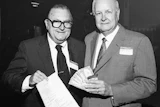 In September 1985, the American Parquet Association's Al Pollard (at left) and Virgil Hendricks sign up Lockwood Flooring as the first NWFA member.