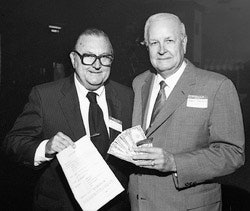 In September 1985, the American Parquet Association's Al Pollard (at left) and Virgil Hendricks sign up Lockwood Flooring as the first NWFA member.