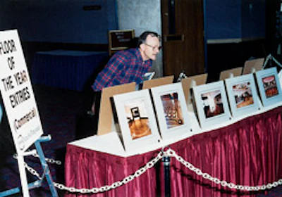 Jack Stuart peruses the entries in the National Wood Flooring Association Floor of the Year contest at the 1991 NWFA convention in Reno, Nev.