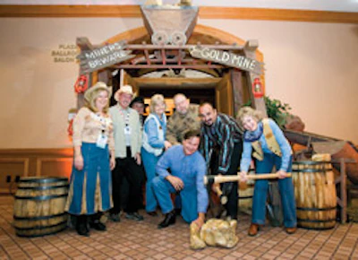 Angela Crowl, Alvin Crowl, John Welch, Tricia Swindoll, Rusty Swindoll, Joe Boone Jr., Jan Kuehn and Daniel Boone (kneeling) were in the western spirit at the National Wood Flooring Association convention in Denver in 2007.