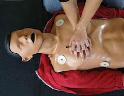 Photo of a person practicing CPR training on a dummy