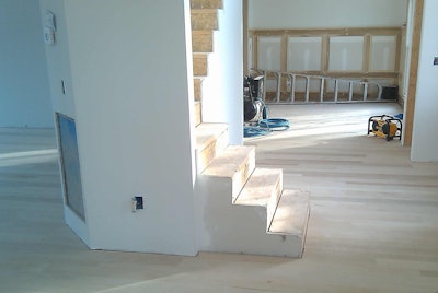 Maple wood floor with stairs in the middle