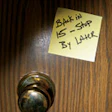 Photo of a post-it note on a door saying 'Be Back in 15'