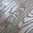 A prefinished solid wood floor damaged by repeated use of a steam mop cleaner.