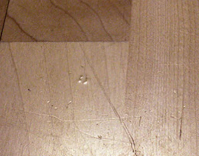 Spots such as this hair trapped in the finish will be visible after recoating unless they are hand-scraped out first; the minor scratches should disapper.