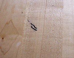It's likely that these marks from a Sharpie marker have penetrated most of the finish and won't come out with a recoat.