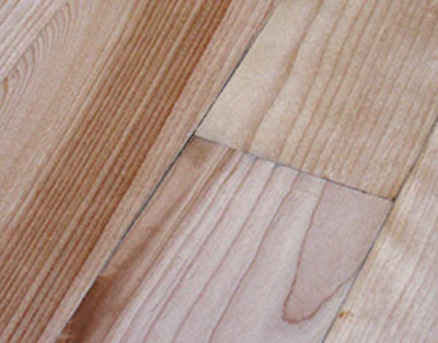 Moisture damage, such as these black lines at board edges from a leaking Christmas tree stand, will still be visible after recoating.