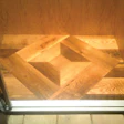 A reclaimed white oak custom-built wood floor medallion in a high-end Florida custom home’s elevator.