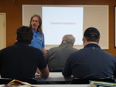 Contractors learn how to install wood flooring during a trade school held by the National Wood Flooring Association (NWFA)