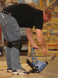 Contractors install wood flooring during a trade school held by the National Wood Flooring Association (NWFA)