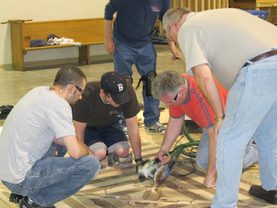 students install wood flooring at National Wood Flooring Association (NWFA) technical school