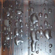 photo closeup of hardwood floor with blisters