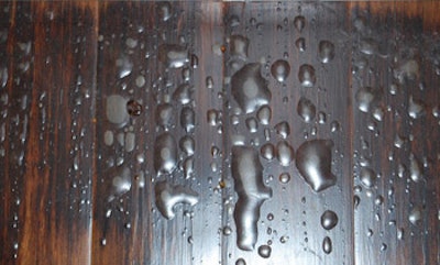 photo closeup of hardwood floor with blisters