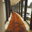 Photo of a herringbone floor running a curved hallway