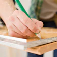 photo of handyman preparing a wooden floor