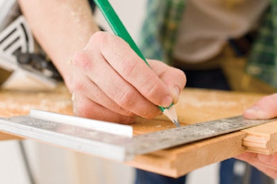 photo of handyman preparing a wooden floor