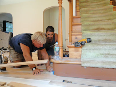 Gary works on an installation job alongside Foreman Pete DiMarco.