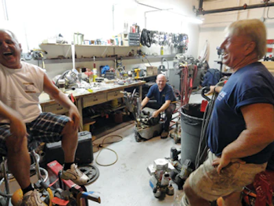 Making a stop to check on some equipment repairs, Gary pauses to share a laugh with Bob Sidoti (left) and Kevin O'Leary, owner at KO Floor Supply.