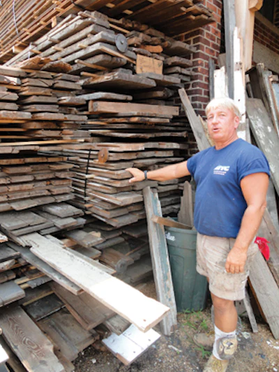 Gary shows off some of Real Antique Wood Mill's stock—including pine, hemlock, oak, chestnut and other species—most of which was taken from old barns.
