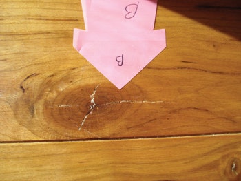 photo of checks originating from knot in wood floor