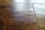 A wear layer held in place as it shrunk in low-humidity conditions led to face-checking on this wood flooring.