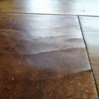 A wear layer held in place as it shrunk in low-humidity conditions led to face-checking on this wood flooring.