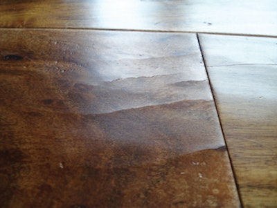 A wear layer held in place as it shrunk in low-humidity conditions led to face-checking on this wood flooring.