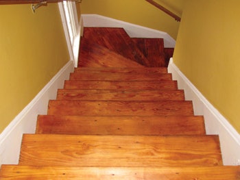 Don Dickel repairs wood flooring at Maine's Rockland Breakwater Lighthouse