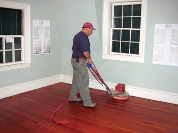Don Dickel repairs wood flooring at Maine's Rockland Breakwater Lighthouse
