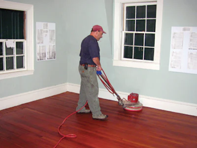 Don Dickel repairs wood flooring at Maine's Rockland Breakwater Lighthouse