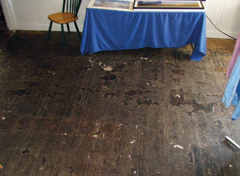 Don Dickel repairs wood flooring at Maine's Rockland Breakwater Lighthouse