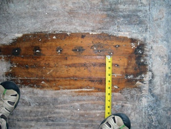 Don Dickel repairs wood flooring at Maine's Rockland Breakwater Lighthouse