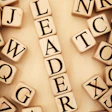 photo of wood blocks forming the word 'leader'