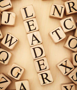 photo of wood blocks forming the word 'leader'