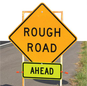 photo of sign saying 'Rough Road Ahead'