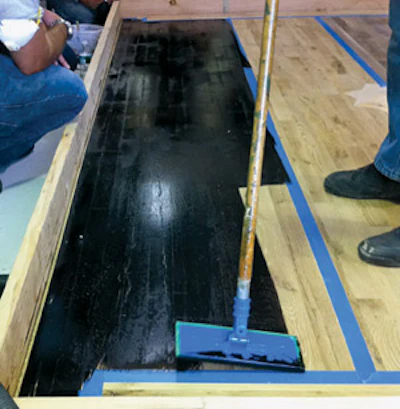 Intense colors can be achieved with dyes, such as this black floor (the photo is from an NWFA technical school in New York City last August; courtesy of Daniel Boone at Jacksonville, Fla.-based Daniel Boone WFT Inc.).